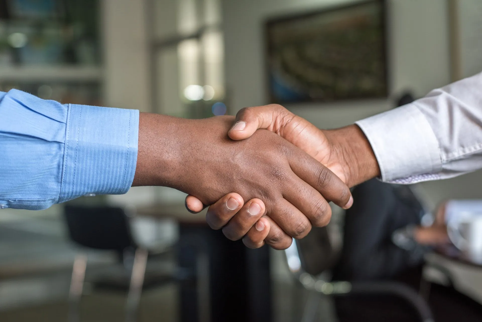 Two people shaking hands in a professional setting, symbolizing an agreement reached through FINRA arbitration.