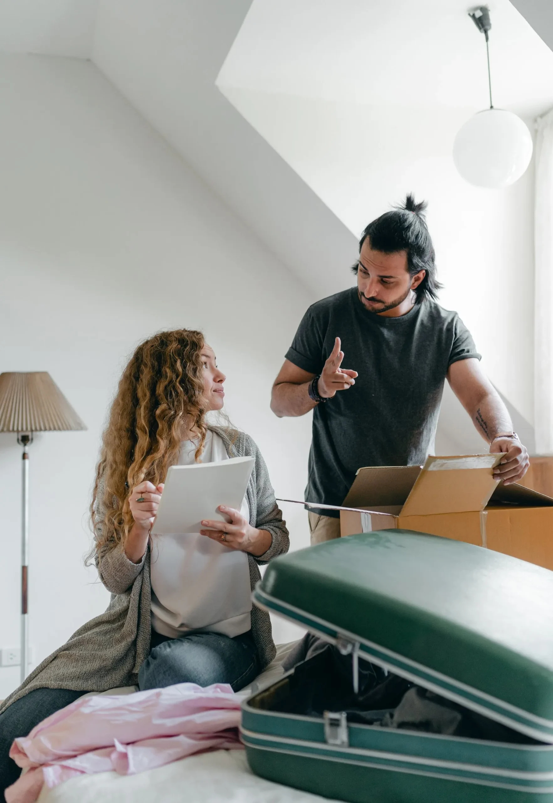 A man and a woman in a room with packed boxes, symbolizing a trust being reformed