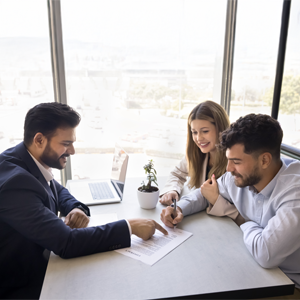 A couple signing a legal document with an attorney, representing the process of setting up a trust in Florida.